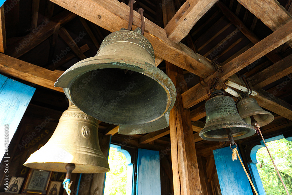 Fototapeta premium Old church bell and prefabricated structure. Close up of old metal, cracked, orthodox church bells. Selective focus. The concept of Orthodoxy.