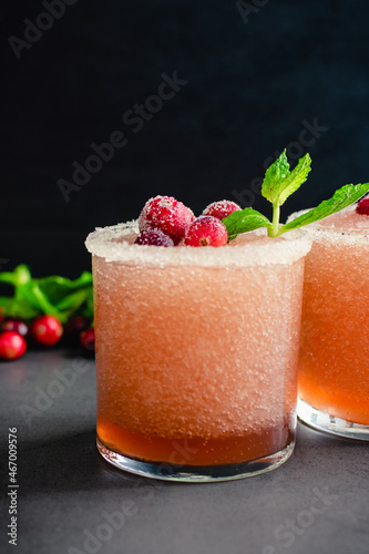 Cranberry Margaritas Garnished with Sugared Cranberries and Mint: Frozen margarita tequila cocktails rimmed with sugar and salt