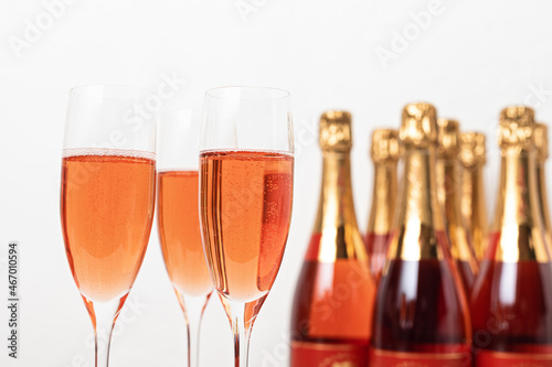 Glasses and bottles of rose champagne or sparkling wine. Christmas, new year party, birthday or wedding celebration concept