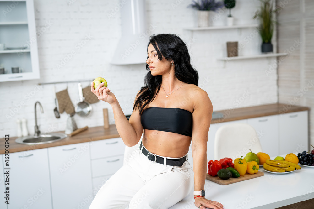 Young beautiful dietolog woman with healthy food. Attractive woman sitting on the table with vegeterian healthy food. Young beautiful dietolog woman with healthy food. Attractive woman sitting on the table with vegeterian healthy food.