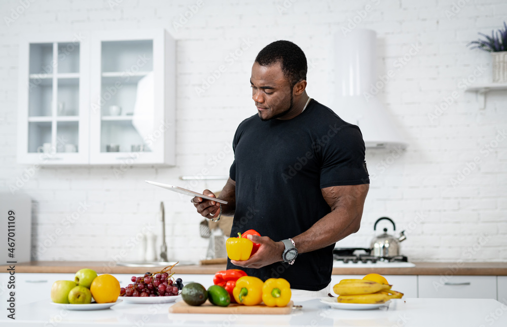 Healthy fresh food holding in man hands indoor. Young handsome man with fruits on the kitchen. Healthy fresh food holding in man hands indoor. Young handsome man with fruits on the kitchen.