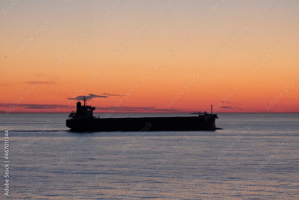 Cargo ship in the Baltic sea during beautiful sunrise.