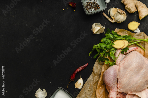 process cooking chicken legs with spices hot pepper ginger garlic greens on black background with woman