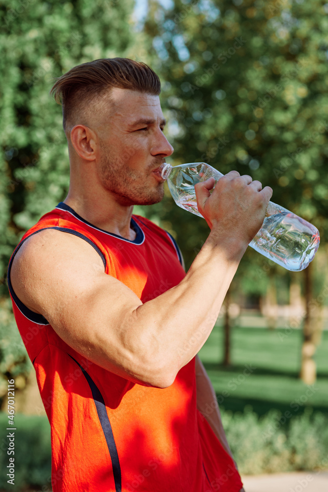 athletic man with dumbbells in his hands outdoors in the park athletic man with dumbbells in his hands outdoors in the park