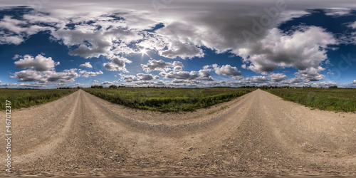 360 hdri panorama on no traffic sand gravel road among fields with blue overcast sky with clouds in equirectangular seamless spherical projection, VR AR content.