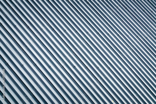 Corrugated metal profile roof installed on a barn house. The roof of corrugated sheet. Roofing of metal profile wavy shape. Modern roof made of metal. Metal roofing. 