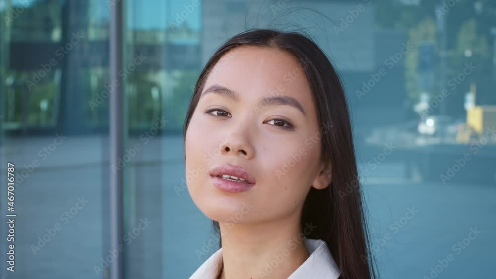 Korean Businesswoman Posing Touching Hair Standing In Urban Area Outside Korean Businesswoman Posing Touching Hair Standing In Urban Area Outside