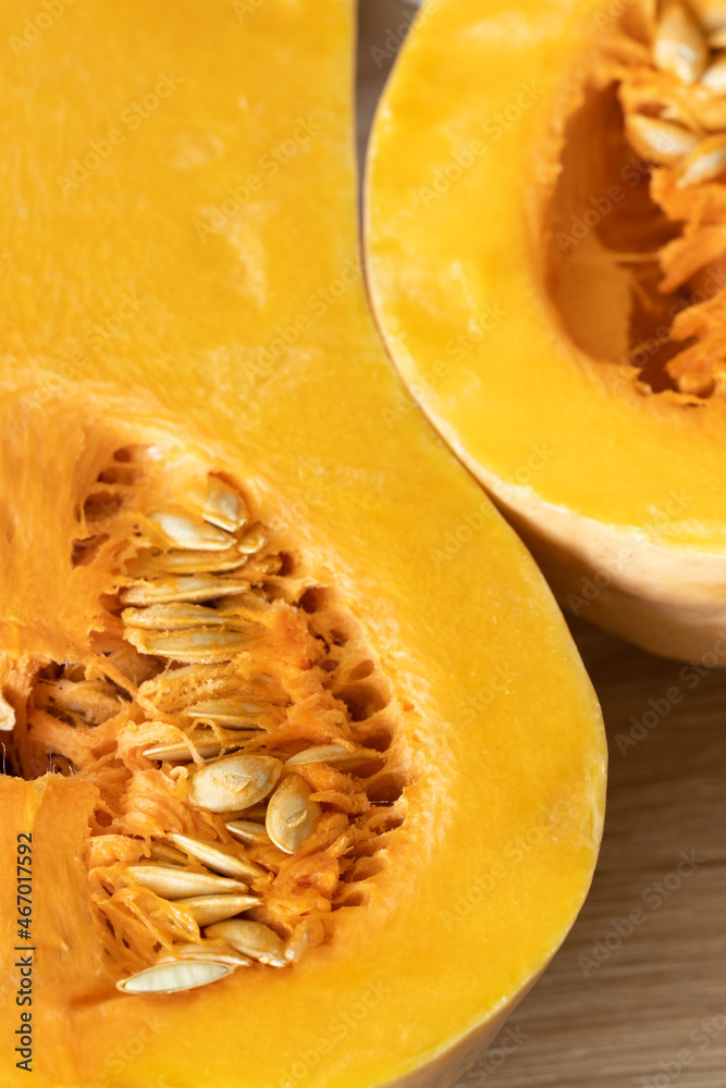 orange pumpkin with seeds cut in half close-up