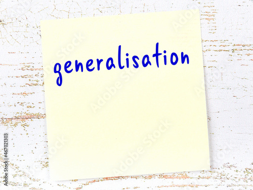 Yellow sticky note on wooden wall with handwritten word generalisation photo