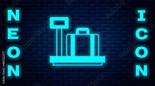 Glowing neon Scale with suitcase icon isolated on brick wall background. Logistic and delivery. Weight of delivery package on a scale. Vector