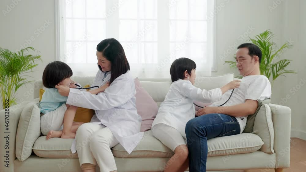 Asian family relationships, father, mother and son having fun playing doctor and patient in their home.
Asian family relationships, father, mother and son having fun playing doctor and patient in their home.