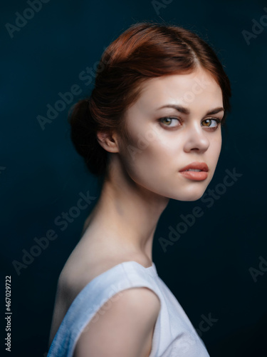 red-haired woman in white dress posing attractive studio look