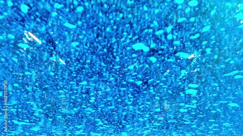 Moving through an automated car wash. Camera is viewing the procedure through an automobile's windshield.
