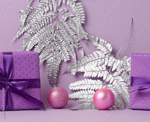 boxes packed in festive purple paper and tied with silk ribbon on a purple background, gift, surprise