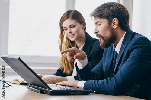 colleagues in the office in front of a laptop career work technologies