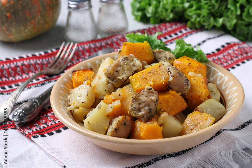 Baked pork with potatoes and pumpkin, homemade hearty dish