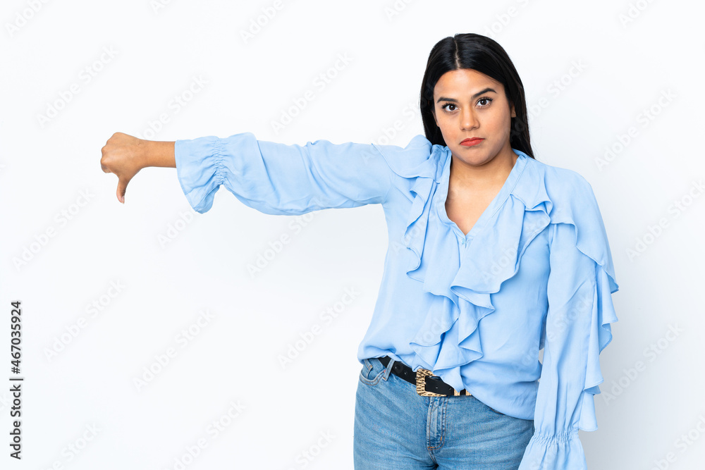 Young latin woman woman isolated on white background showing thumb down with negative expression Young latin woman woman isolated on white background showing thumb down with negative expression