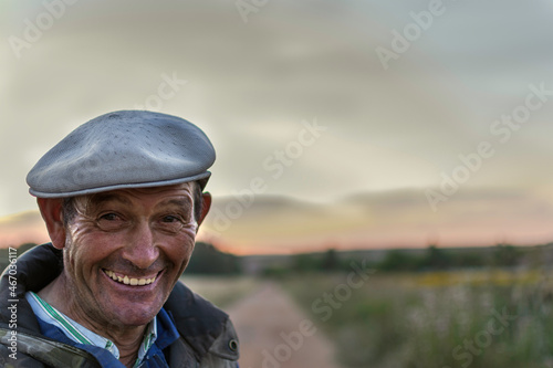 Close up of happy farmer in a field at the sunset. 