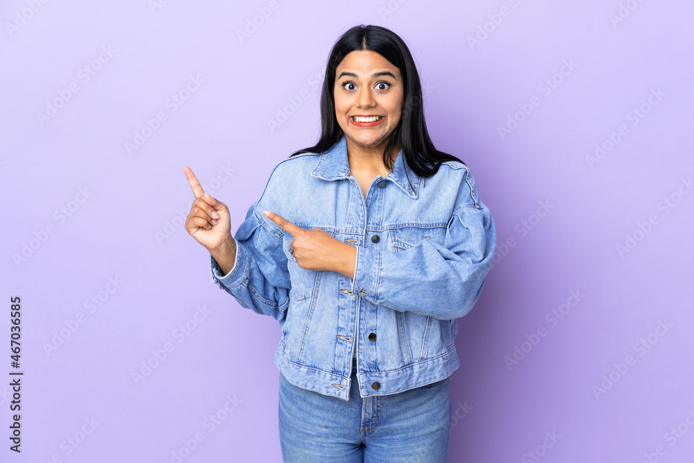 Young latin woman woman over isolated background frightened and pointing to the side Young latin woman woman over isolated background frightened and pointing to the side