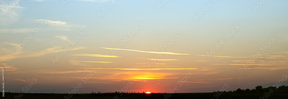 Scene of sunset in the summer with a cloudy sky background. Landscape