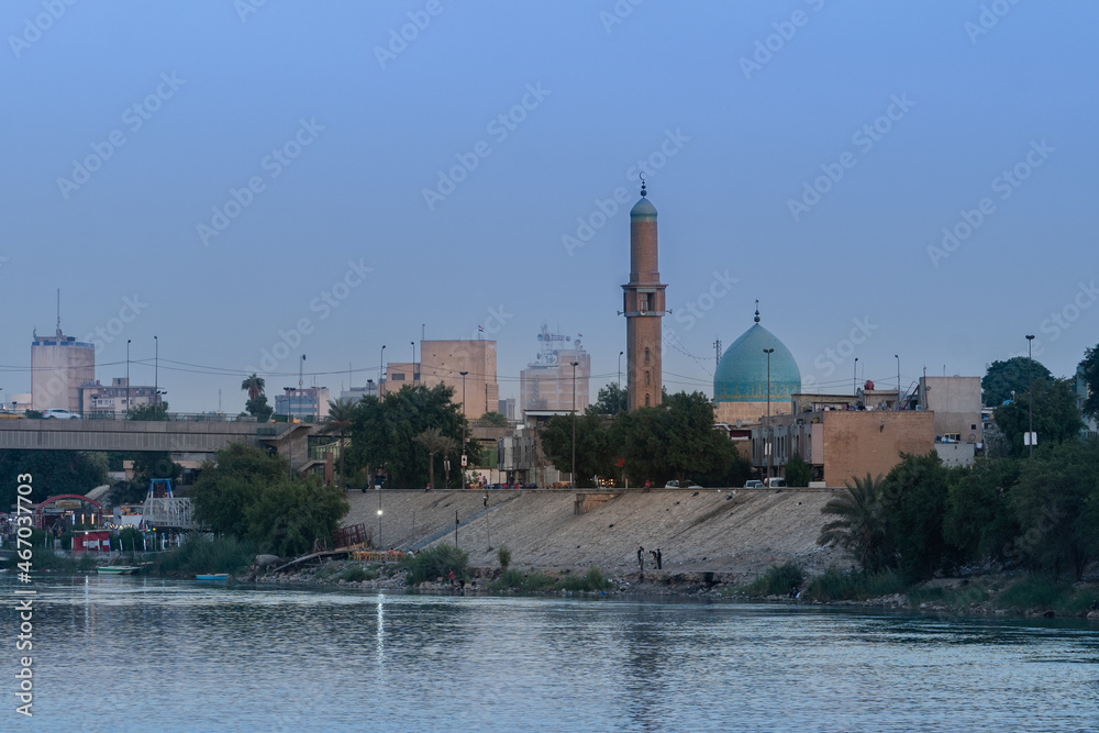 Baghdad, Iraq - October 11, 2021: Evening View of Al Takarta Mosque Overlooking on Tigris River with the Great Gate Bridge in Background Located in Haifaa Street in Baghdad.