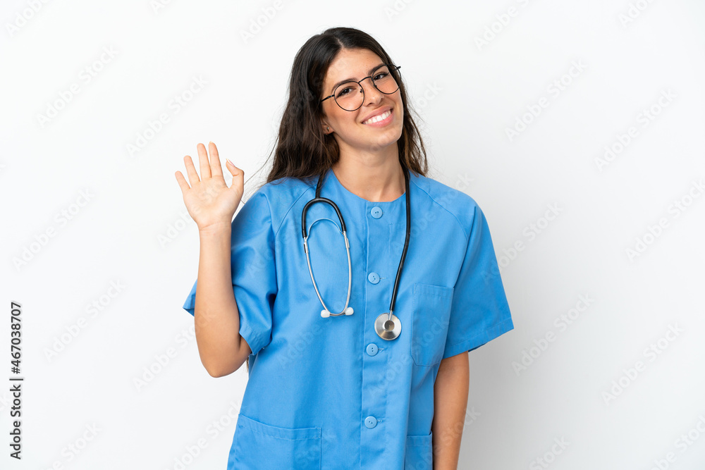 Young surgeon doctor caucasian woman isolated on white background saluting with hand with happy expression Young surgeon doctor caucasian woman isolated on white background saluting with hand with happy expression
