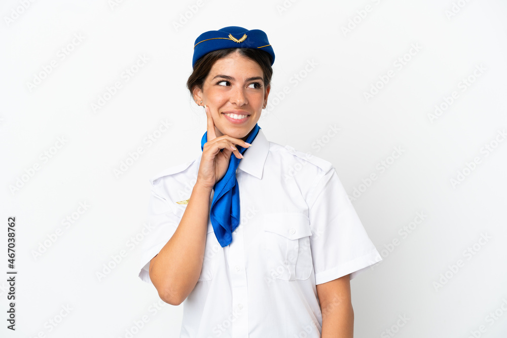 Airplane stewardess caucasian woman isolated on white background thinking an idea while looking up Airplane stewardess caucasian woman isolated on white background thinking an idea while looking up
