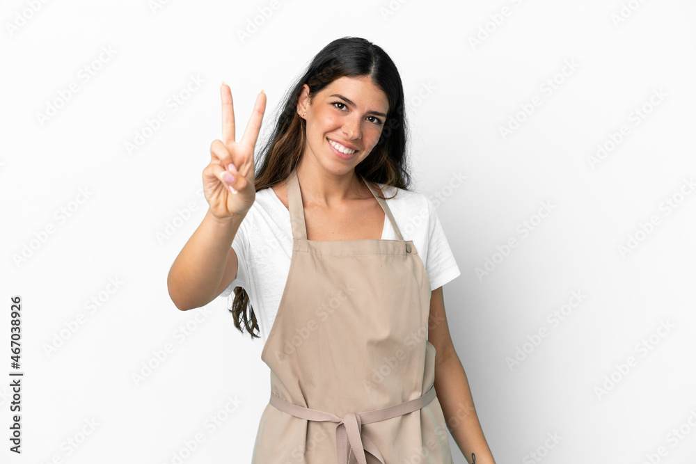 Restaurant waiter over isolated white background smiling and showing victory sign Restaurant waiter over isolated white background smiling and showing victory sign