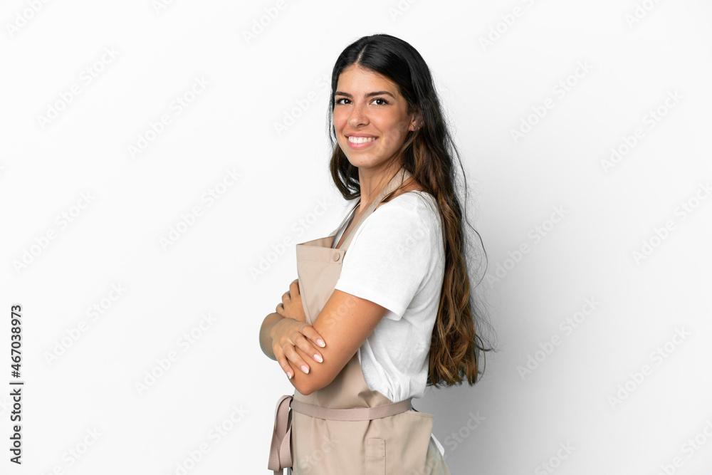 Restaurant waiter over isolated white background with arms crossed and looking forward Restaurant waiter over isolated white background with arms crossed and looking forward