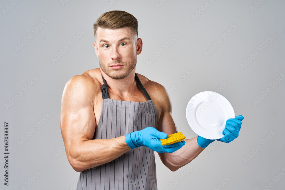 a man in an apron washing dishes cleaning service