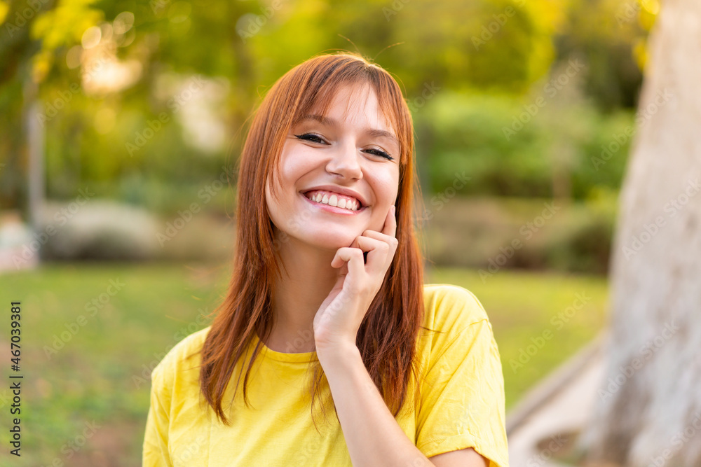 Young pretty redhead woman at outdoors With happy expression Young pretty redhead woman at outdoors With happy expression