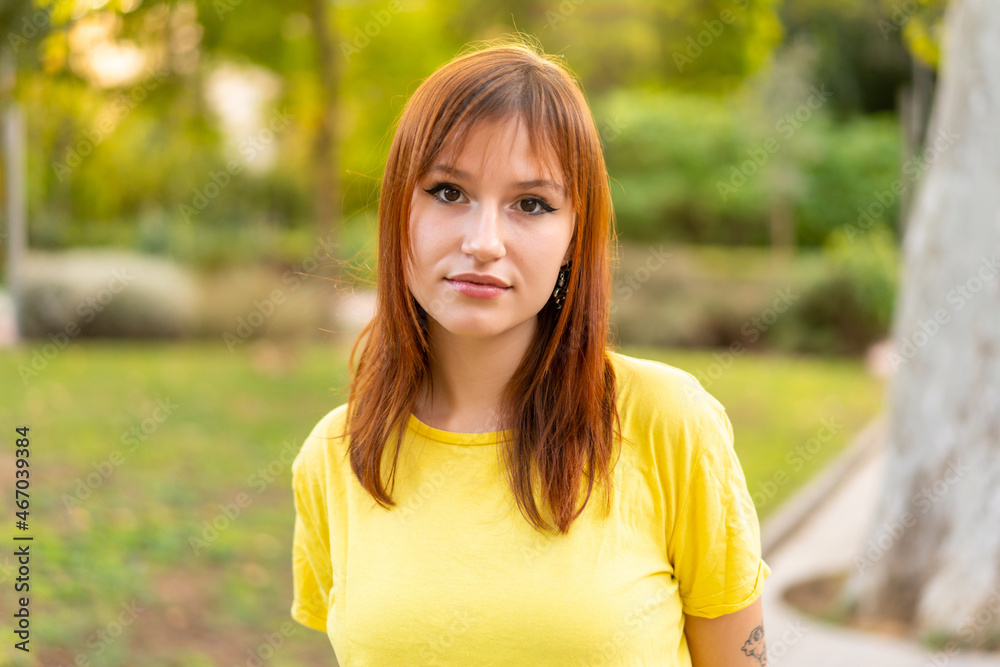 Young pretty redhead woman at outdoors . Portrait Young pretty redhead woman at outdoors . Portrait