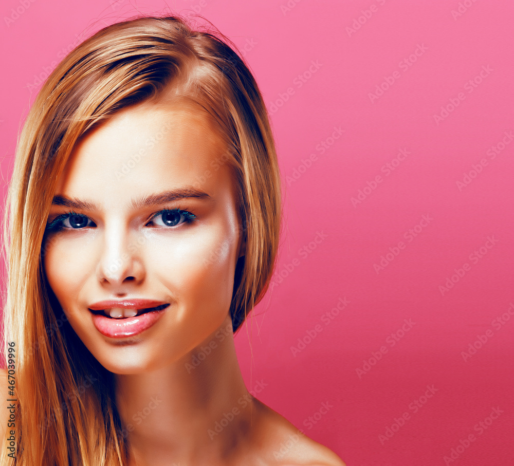 young pretty blonde real woman with hairstyle close up and makeup on pink background smiling young pretty blonde real woman with hairstyle close up and makeup on pink background smiling