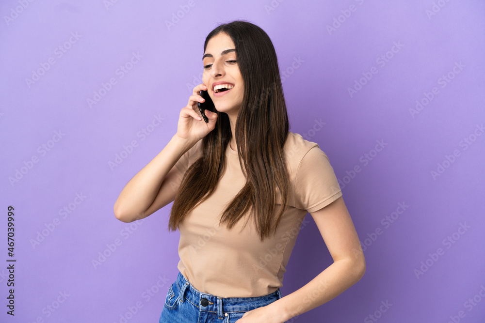 Young caucasian woman using mobile phone isolated on purple background looking to the side and smiling Young caucasian woman using mobile phone isolated on purple background looking to the side and smiling