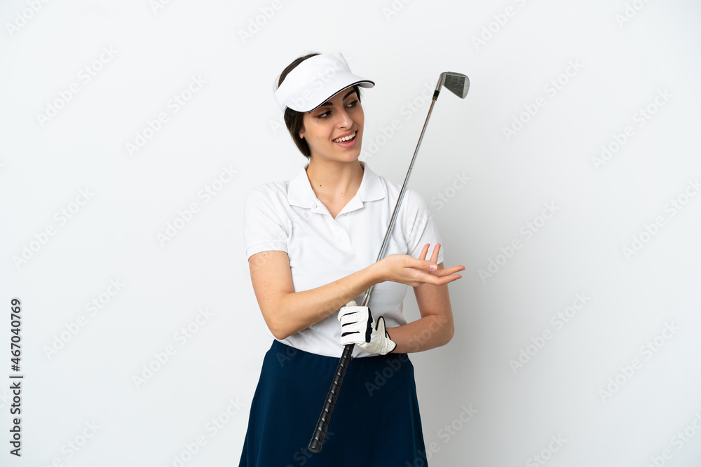 Handsome young golfer player woman isolated on white background extending hands to the side for inviting to come Handsome young golfer player woman isolated on white background extending hands to the side for inviting to come