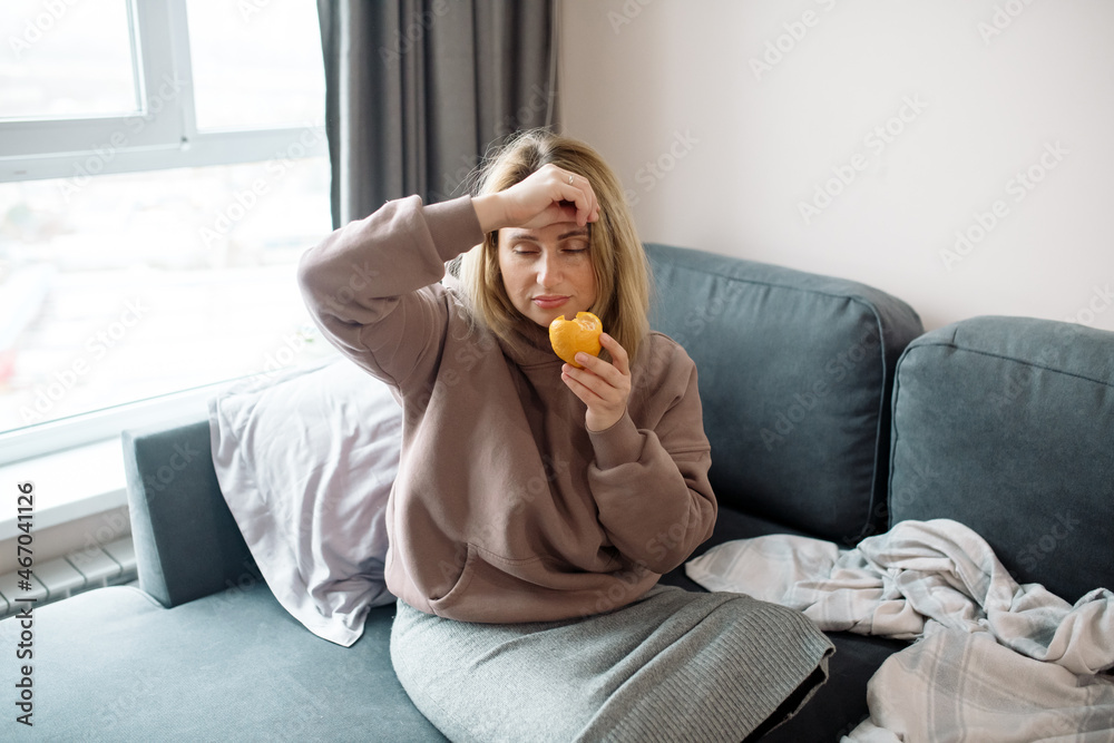 Long covid syndrome - increased fatigue, lack of strength, reduced immunity, memory problems and anosmia - loss of smell. Woman sniffs citrus fruits and does not smell Long covid syndrome - increased fatigue, lack of strength, reduced immunity, memory problems and anosmia - loss of smell. Woman sniffs citrus fruits and does not smell