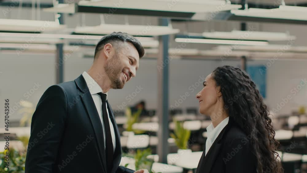 Two Coworkers Giving High-Five Celebrating Success At Work In Office Two Coworkers Giving High-Five Celebrating Success At Work In Office