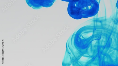 Blue pigment ink water explosion from above white background.