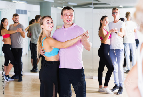 Dancing positive swedish couples learning salsa at dance class
