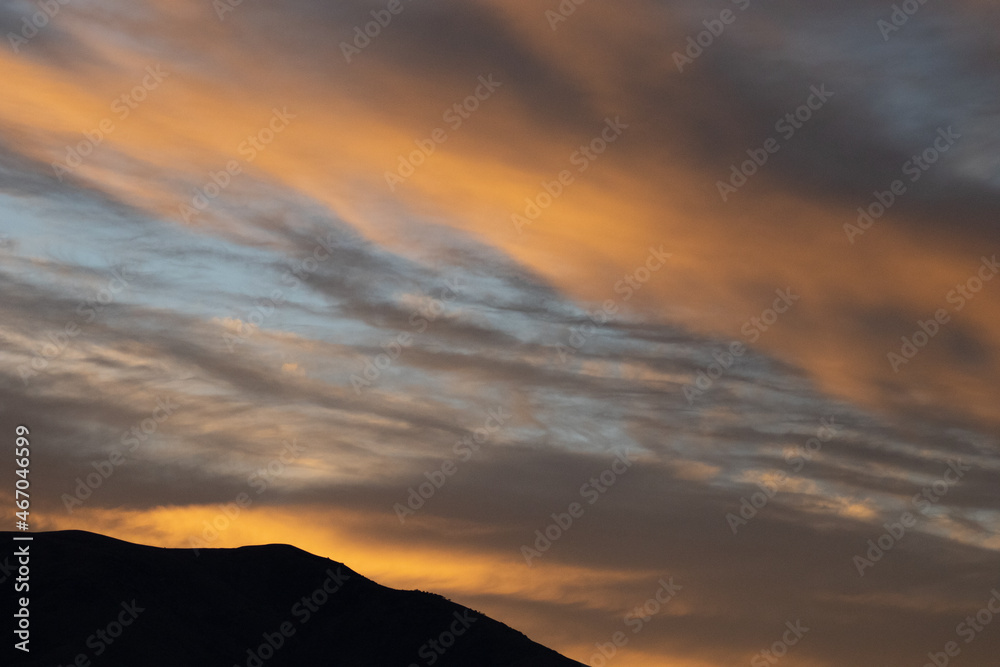 Moody clouds at sunrise over mountains Moody clouds at sunrise over mountains