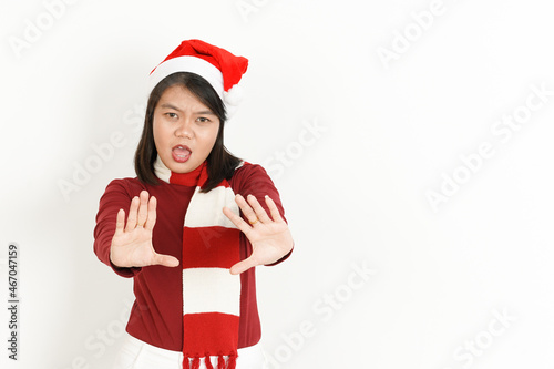 Stop Hand Gesture of Beautiful Asian Woman Wearing Red Turtleneck and Santa Hat Isolated On White Background