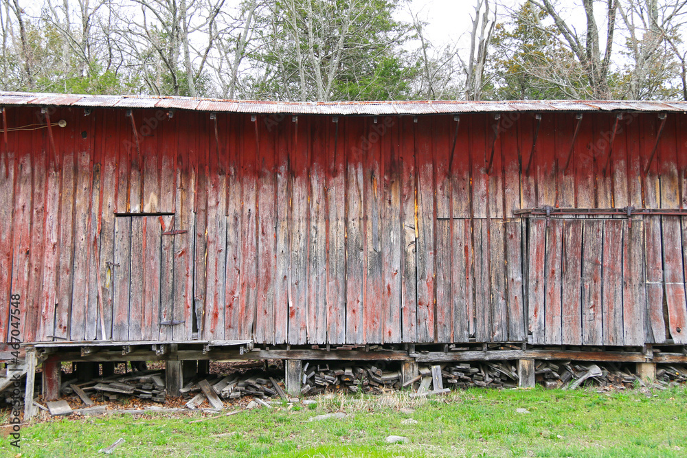 rural farm shed barn abandoned derelict peeling red paint shack building vintage retro farming agricultural background rural farm shed barn abandoned derelict peeling red paint shack building vintage retro farming agricultural background