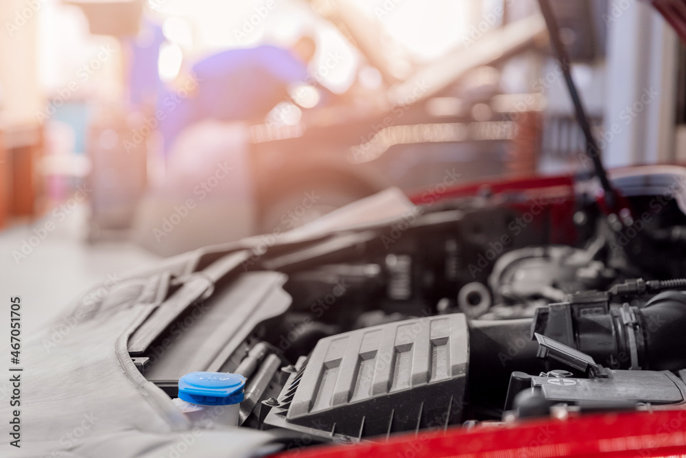 Concept closeup car repair service. Auto mechanic working in garage Concept closeup car repair service. Auto mechanic working in garage