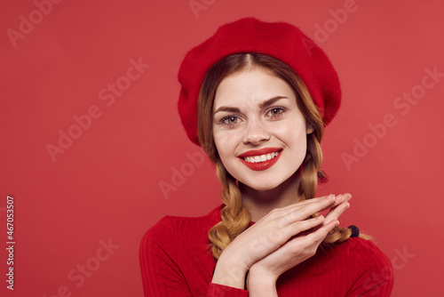 cheerful woman with a red cap on his head glamor isolated background