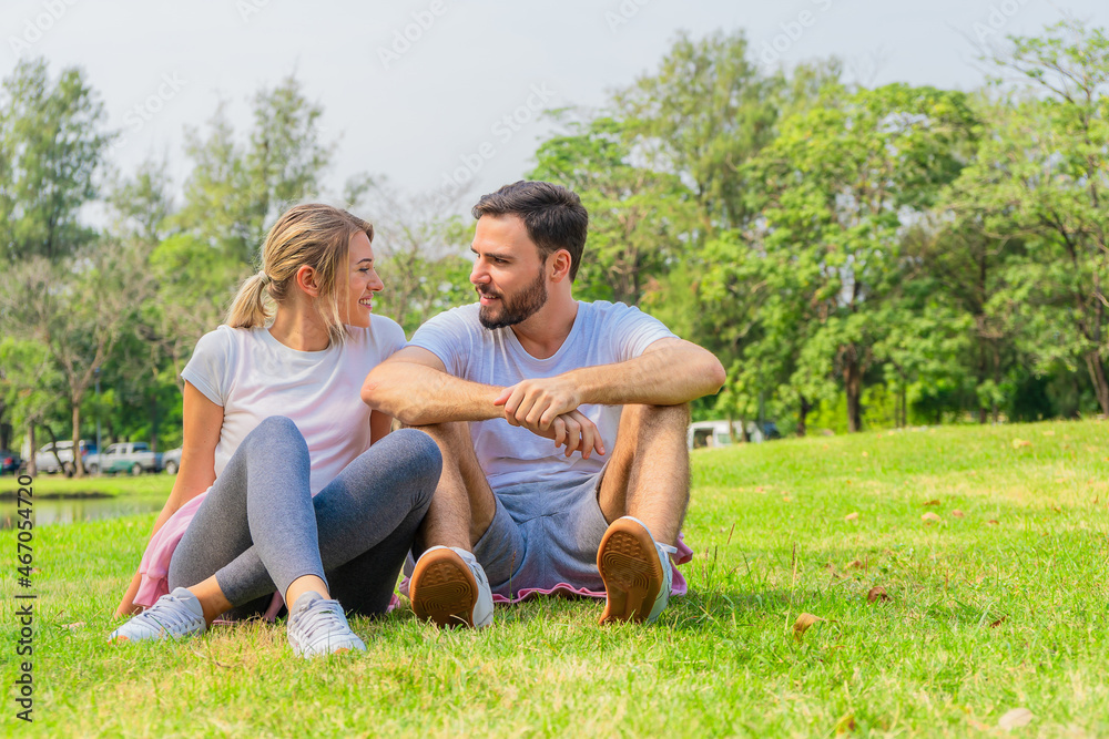 athletic couple sitting for relax together after work out outdoors athletic couple sitting for relax together after work out outdoors