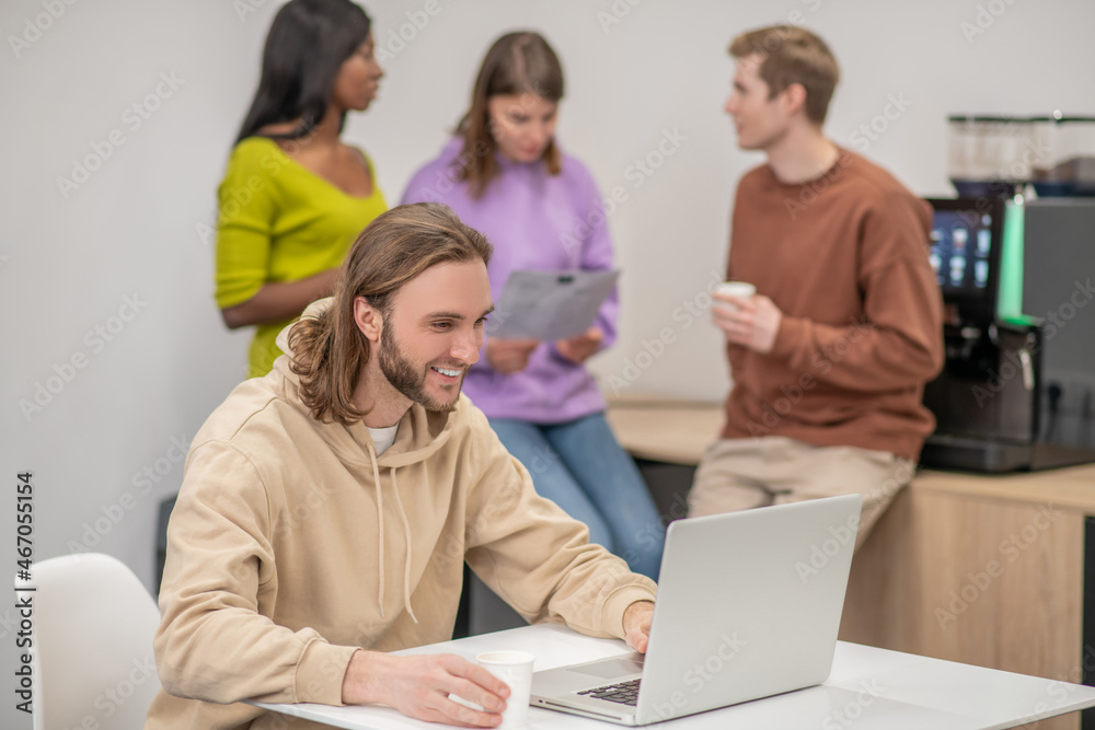 A group of colleagues discussing something and looking involved A group of colleagues discussing something and looking involved