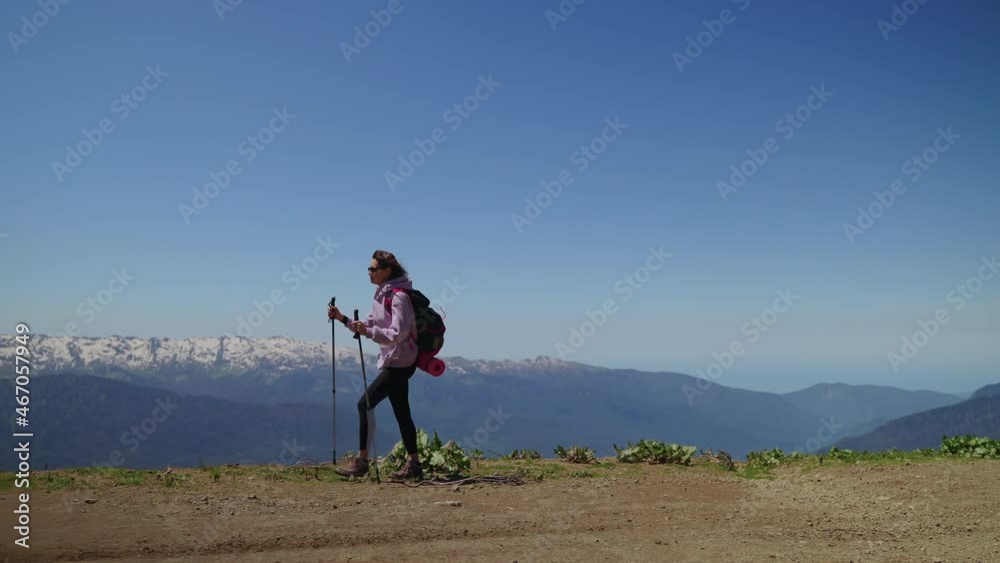 lonely female tourist is hiking in mountains at summer vacation lonely female tourist is hiking in mountains at summer vacation
