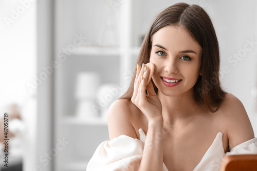 Pretty young woman applying...