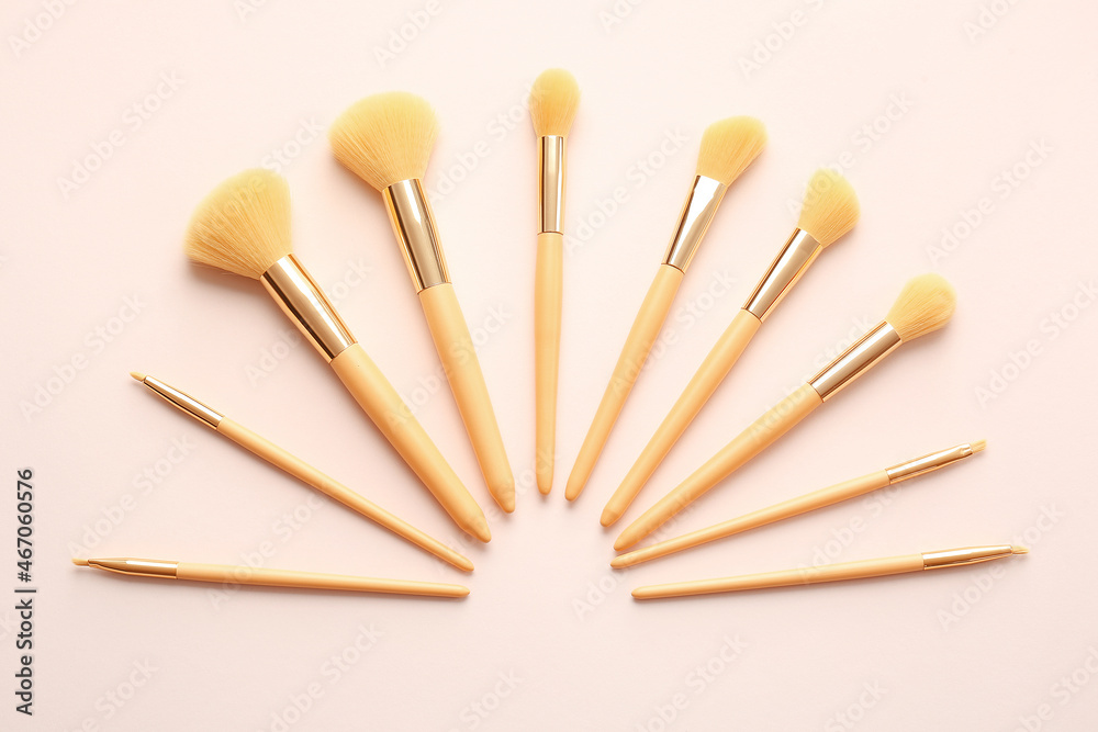 Set of beautiful makeup brushes on color background Set of beautiful makeup brushes on color background