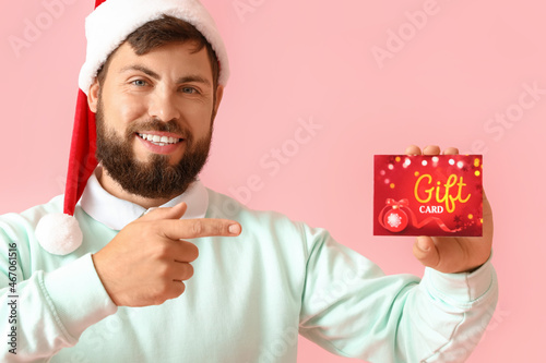 Handsome man in Santa hat p...